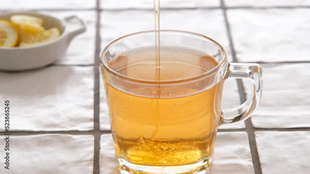 adding honey in a cup of in a cup of hot sage tea
