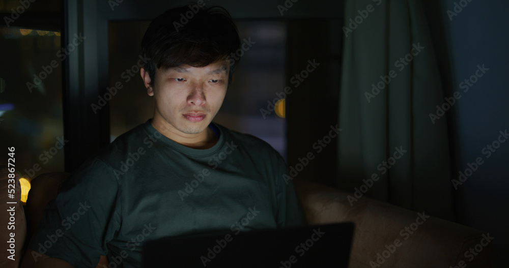 Man work on laptop computer at night Man work on laptop computer at night
