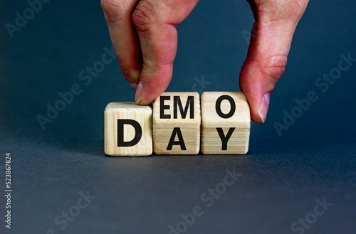 Demo day symbol. Concept words Demo day on wooden cubes. Businessman hand. Beautiful grey table grey background. Business and demo day concept. Copy space.
