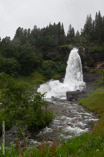 Water from the Fosselva river drops down the 50 m high powerful Steindalsfossen  Norway