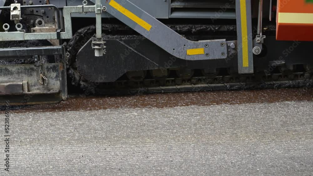 Replacing old asphalt when repairing the road surface. Asphalt paver laying bitumen and new hot asphalt. Road repair in Europe. Construction of a new road, reconstruction of the road surface Replacing old asphalt when repairing the road surface. Asphalt paver laying bitumen and new hot asphalt. Road repair in Europe. Construction of a new road, reconstruction of the road surface