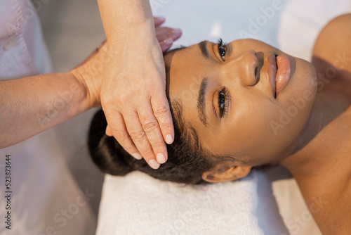 african woman in yellow towel on facial massage	
