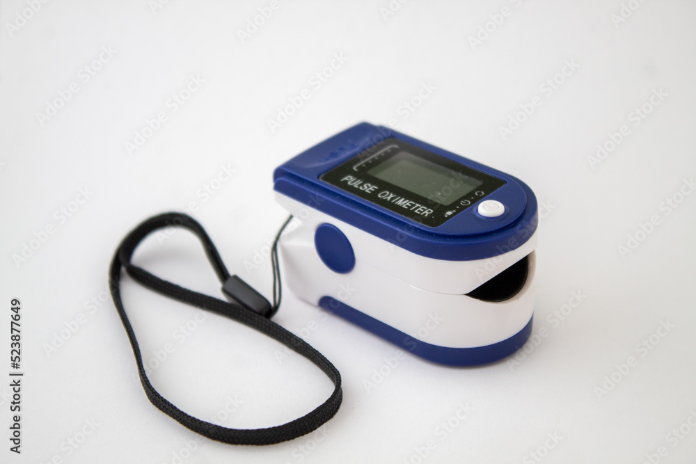 A blue pulse oximeter on the isolated white background A blue pulse oximeter on the isolated white background
