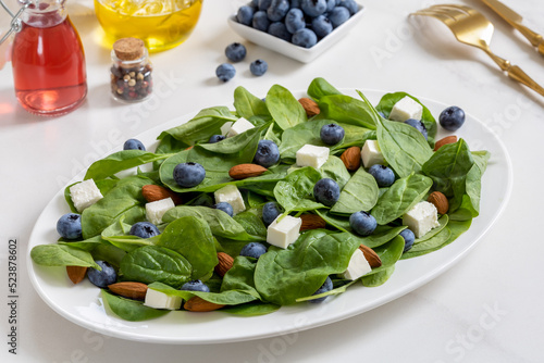 Fotografie, Obraz Spinach salad with blueberries, toasted almond, feta cheese and fruit vinegar dr