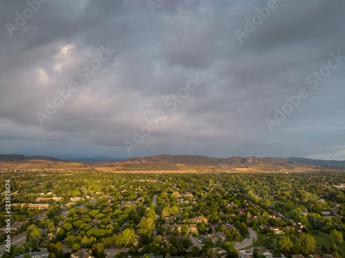 summer morning over Fort Collins and foothills of Rocky Mountains in northern Colorado, aerial view with heavy clouds