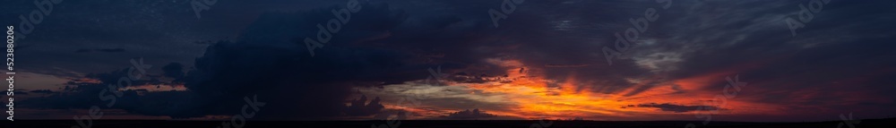 Landscape with bloody sunset. Panorama. Tragic gloomy sky. The last flashes of the sun on the storm clouds. Landscape with bloody sunset. Panorama. Tragic gloomy sky. The last flashes of the sun on the storm clouds.