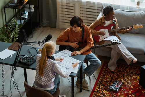 Fotografía High angle view of young musicians writing songs together and playing musical in