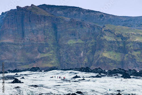 View of people hike tour through Myrdalsjokull Glacier photo