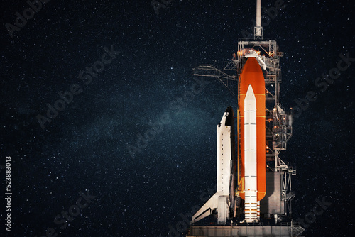 Space shuttle stands at the base and prepares to launch against the background of the starry sky. Space rocket, concept photo