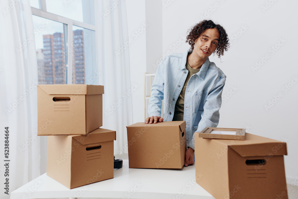 handsome guy unpacking with box in hand interior handsome guy unpacking with box in hand interior