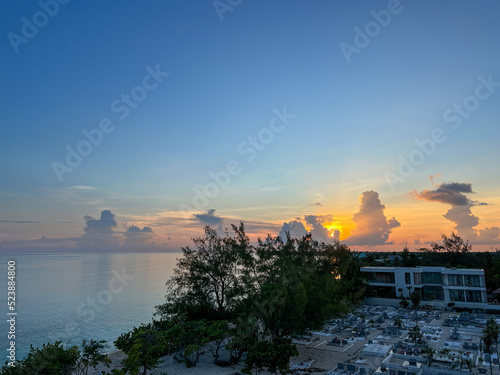An aerial view of Cemetery Beach on Seven Mile Beach in Grand Cayman Island with a beautiful sunset.