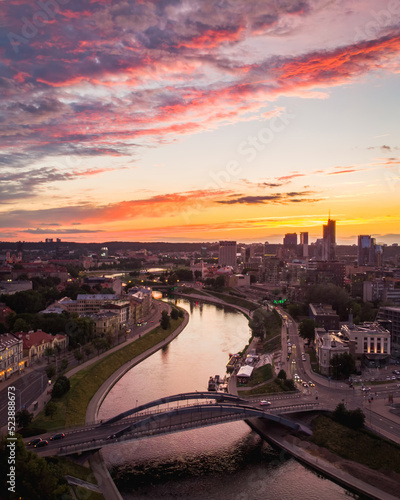Neris river with Mindaugas bridge view and business district buildings in Lithuania capital Vilnius at scenic sunset in summer