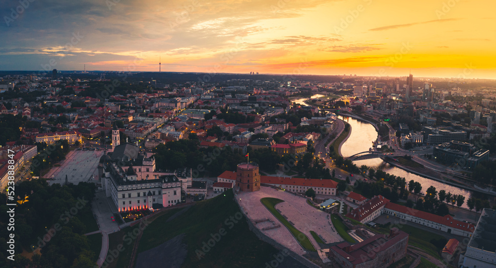 Aerial dramatic view Gediminas old castle tower in Old Town and Vilnius city panorama background, capital city of Lithuania. Scenic landmarks and sightseeing in eastern europe. Travel Lithuania concep