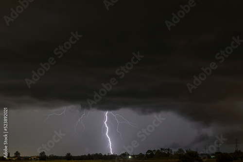A summer storm with large lightnings over the Tuscan countryside of Bientina, Pisa, Italy