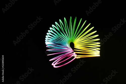 Closeup shot of a colorful slinky isolated on a black background photo