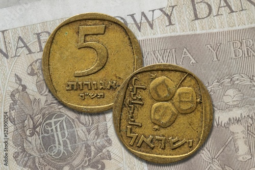Israeli shekel coin obverse and reverse on banknote