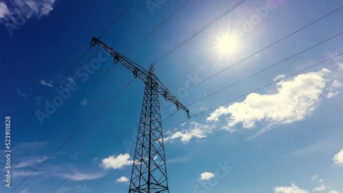 Time-lapse of an electric utility pole from a low angle view with clouds in the background photo