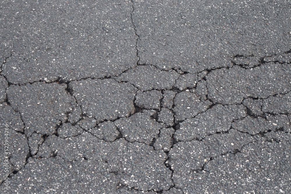 Fototapeta premium Asphalt Surface Split and Cracked