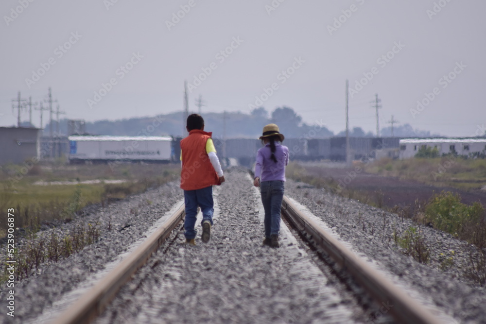 girl walks on the tracks
