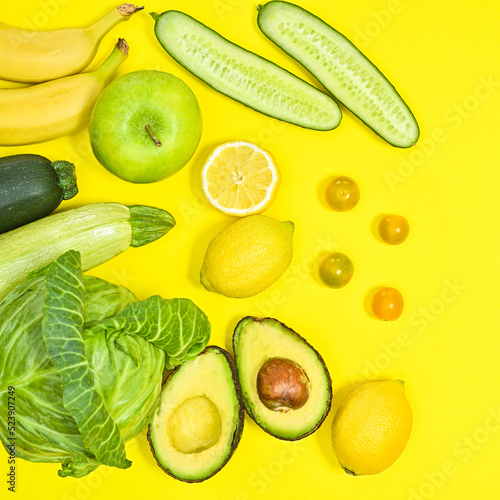 Fototapeta Naklejka Na Ścianę i Meble -  Creative layout of green and yellow fruits and vegetables on yellow background. Antioxidant and healthy lifestyle concept. Flat lay
