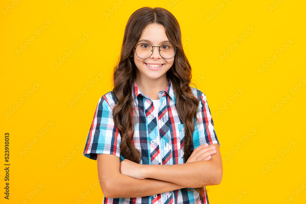 Teenager kid crossed arms with confidence isolated on yellow. Confident teen child girl crossed hands.