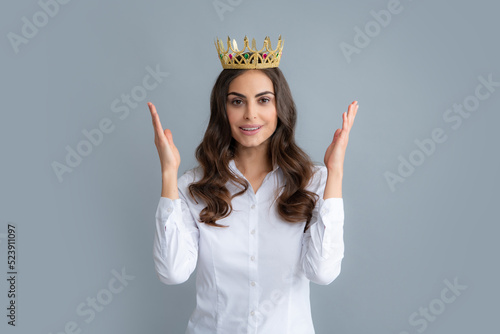 Proud arrogant woman with gold crown. Happy woman in crown, self confident queen, princess in diadem tiara. Selfishness concept. photo