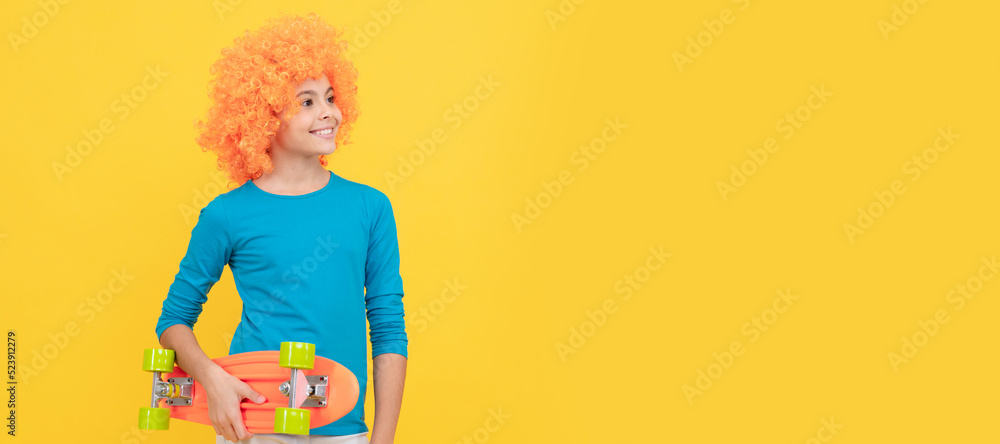 happy teen girl in fancy clown wig hold penny board, childhood. Funny teenager child in wig, party poster. Banner header, copy space. happy teen girl in fancy clown wig hold penny board, childhood. Funny teenager child in wig, party poster. Banner header, copy space.