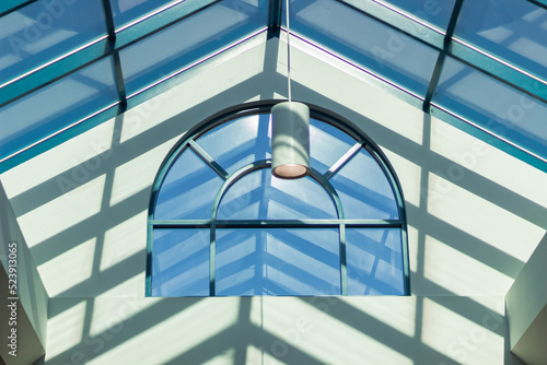 Modern loft Interior design. Sun rays and big arch window. Skylight, abstract