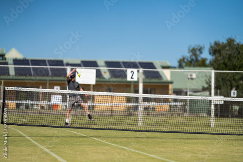  Amateur playing tennis at a tournament and match on grass in Melbourne, Australia 