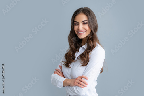 Happy smiling woman portrait. Attractive young pretty cheerful girl in casual clothing feeling happy and carefree, isolated gray background.