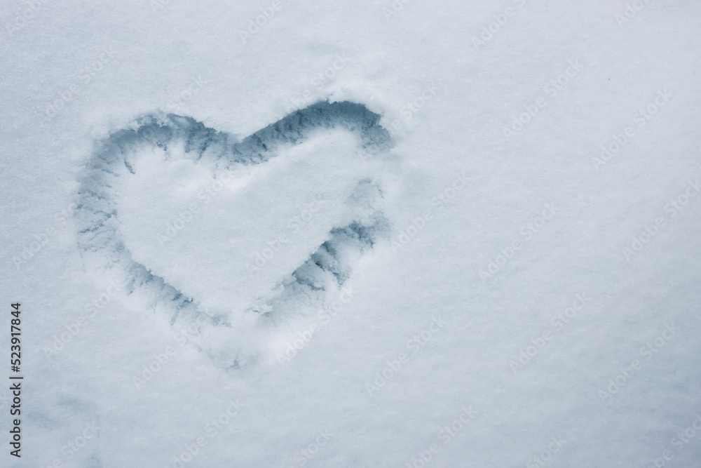 Heart shape drawn on the fresh snow