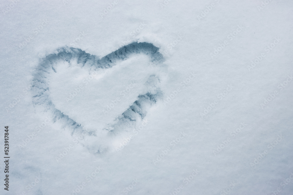 Heart shape drawn on the fresh snow Heart shape drawn on the fresh snow