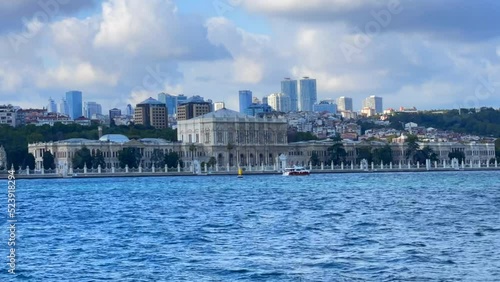 Time-lapse of boats passing through the sea with Dolmabahce palace in the back, Istanbul, Turkey photo
