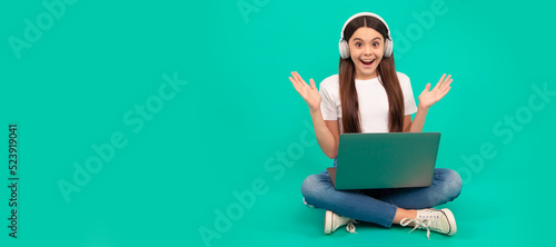 surprised girl buy online. back to school. teen influencer blogging. webinar in wireless headset. School girl portrait with laptop, horizontal poster. Banner header with copy space. © Olena