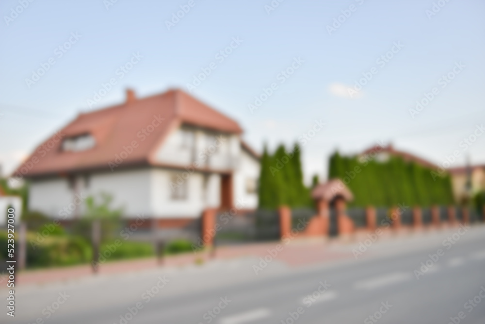 Blurred view of suburban street with beautiful house Blurred view of suburban street with beautiful house