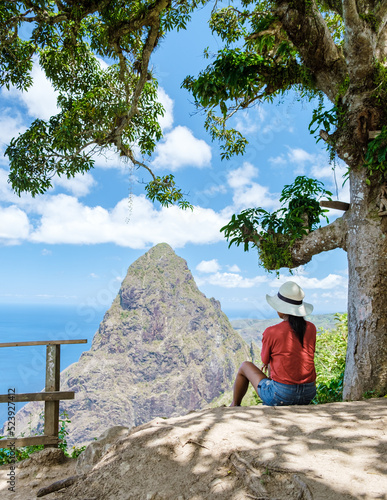 Asian women hiking in the mountains of Saint Lucia Caribbean, nature trail in the jungle of Saint Lucia with a look at the huge Pitons. 