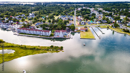 Chincoteague Island, marinas, houses and motels with parking lots. Road along the bay. Drone view. photo