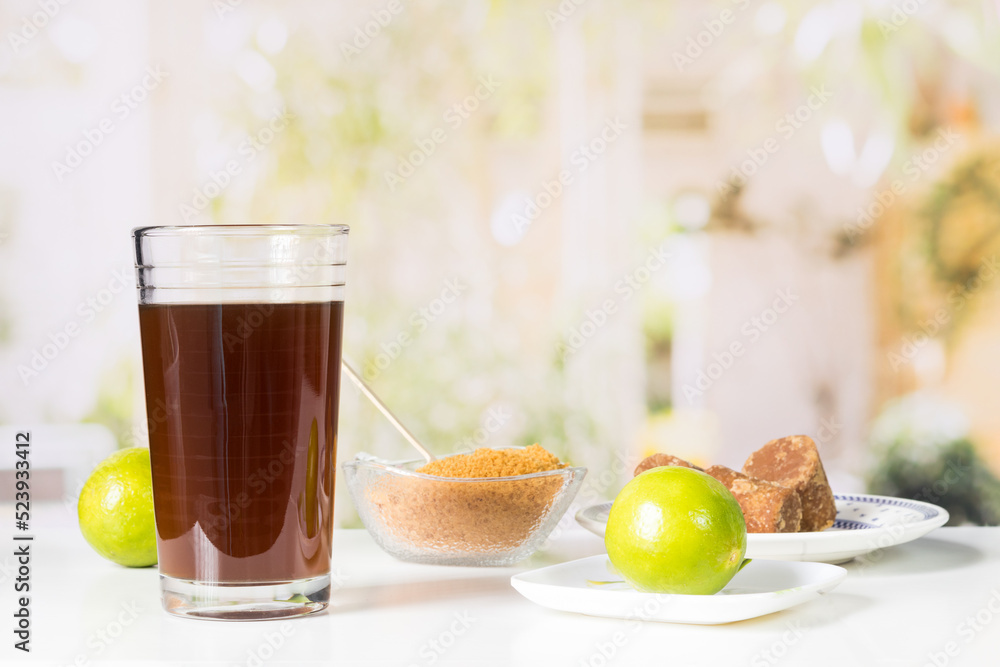 granulated panela and agua de panela and lemon or sugar cane sweets and lemon in the kitchen, typical food of Colombia granulated panela and agua de panela and lemon or sugar cane sweets and lemon in the kitchen, typical food of Colombia