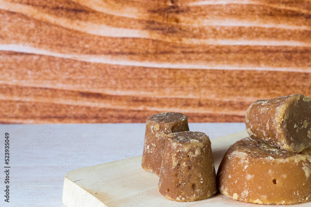Panela cubes or sweet sugar cane with wooden background, typical food of Colombia Panela cubes or sweet sugar cane with wooden background, typical food of Colombia