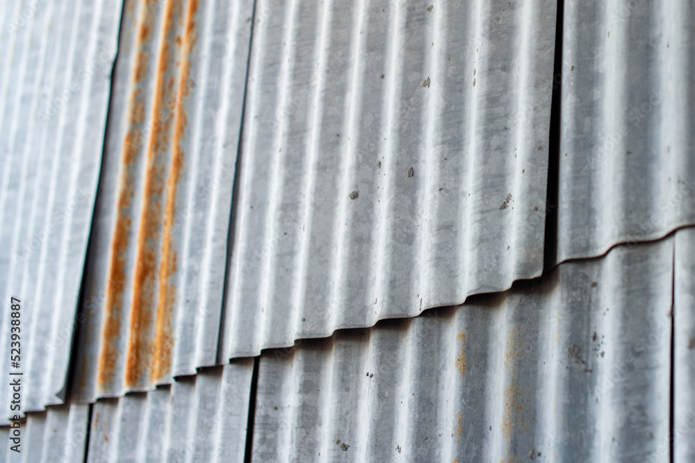 Multiple sections of galvanized weathered corrugated metal panels on