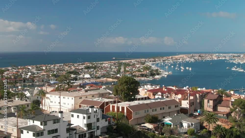 Aerial view of Orange County coastal neighborhood with coastal homes and luxury real estate houses close the sea during the day. Aerial view of Orange County coastal neighborhood with coastal homes and luxury real estate houses close the sea during the day.