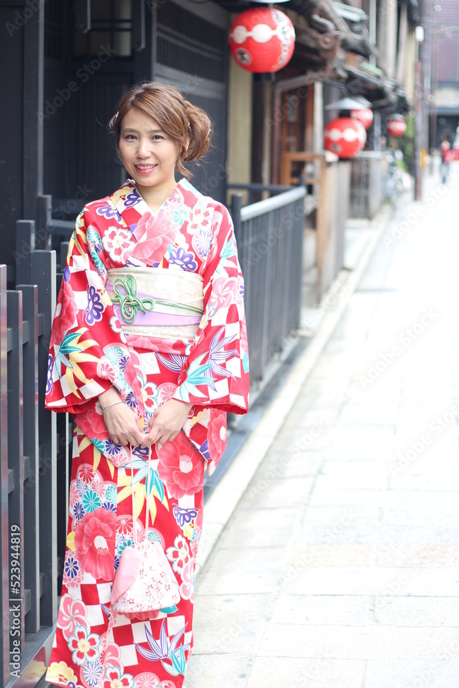 Portrait of beautiful woman wearing Japanese Kimono in front of a street in Kyoto, Japan Portrait of beautiful woman wearing Japanese Kimono in front of a street in Kyoto, Japan