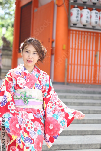 Portrait of beautiful girl wearing japanese kimono in front of Yasaka Shrine, Kyoto, Japan