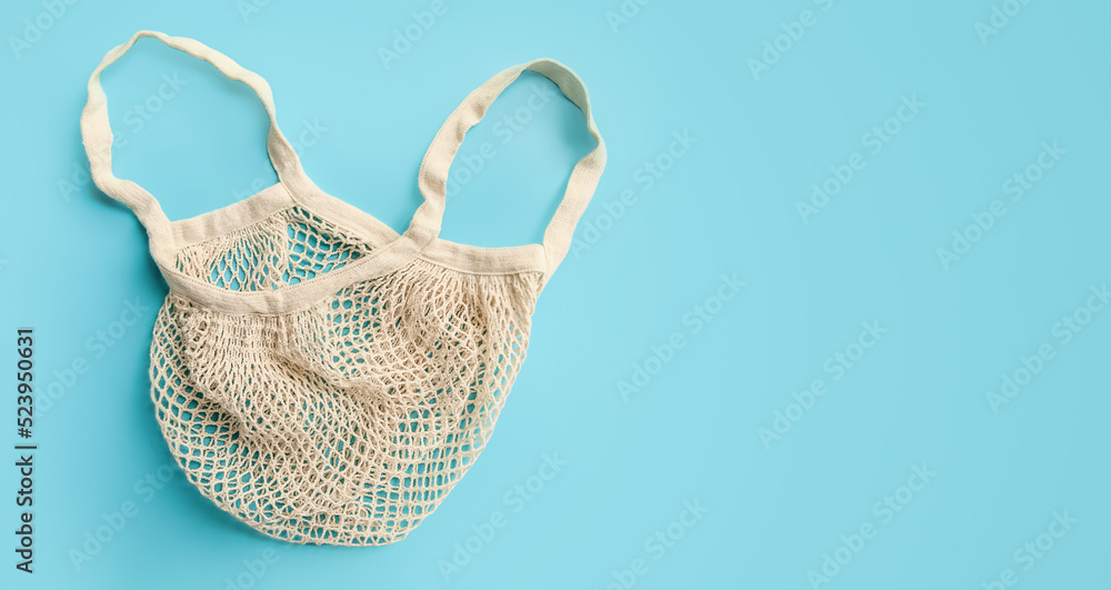 Fototapeta premium trendy eco friendly organic net bag isolated over blue background