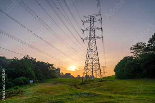 Wallpaper Mural Transmission electricity steel pylon tower. Green energy sustainability and renewable concept during sunrise Torontodigital.ca