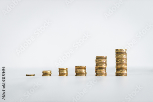 growing stacks of coins representing increasingly expensive prices or savings and compound interests increasing, finance and money concept photo