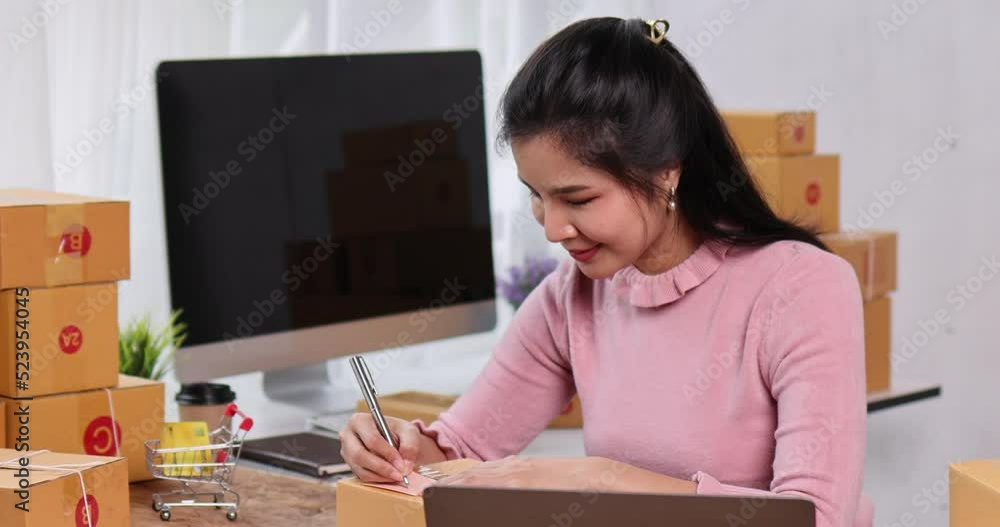 Portrait of young Asian woman working SME with a box at home the workplace.start-up small business owner, small business entrepreneur SME or freelance business online and delivery concept. Portrait of young Asian woman working SME with a box at home the workplace.start-up small business owner, small business entrepreneur SME or freelance business online and delivery concept.