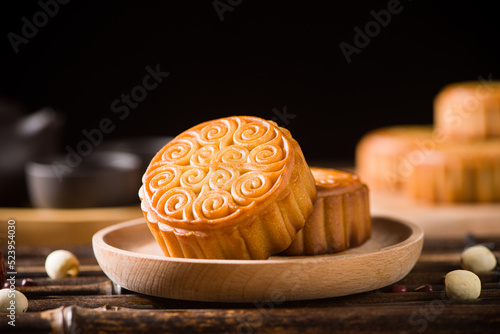 Traditional Chinese mid autumn festival mooncake on wooden table photo
