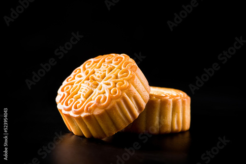 Traditional Chinese mid autumn festival mooncake isolated on black background photo