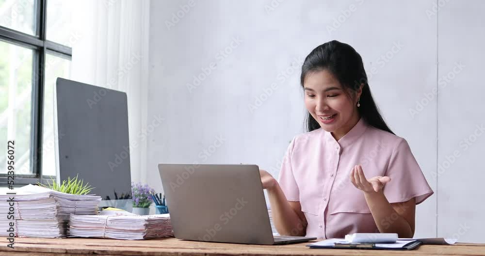 Asian business women have the joy of talking on a laptop computer at the office desk. doing accountant on a calculator to calculate business data documents. Asian business women have the joy of talking on a laptop computer at the office desk. doing accountant on a calculator to calculate business data documents.
